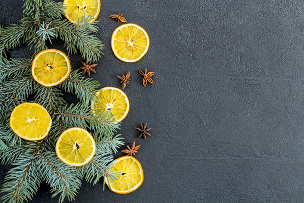 postcard, frame, banner on black concrete from above with Christmas decorations, oranges New Year. branch of blue spruce. Flat lay. - Photo, image