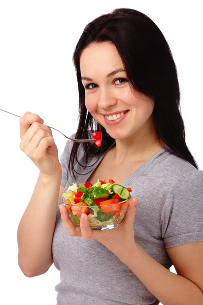 Jeune femme séduisante mange une salade de légumes
 - Photo, image