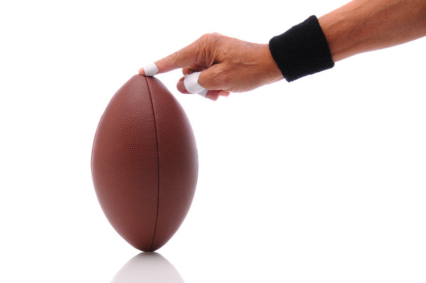 Hand holding a football ready for kicking - Fotoğraf, Görsel