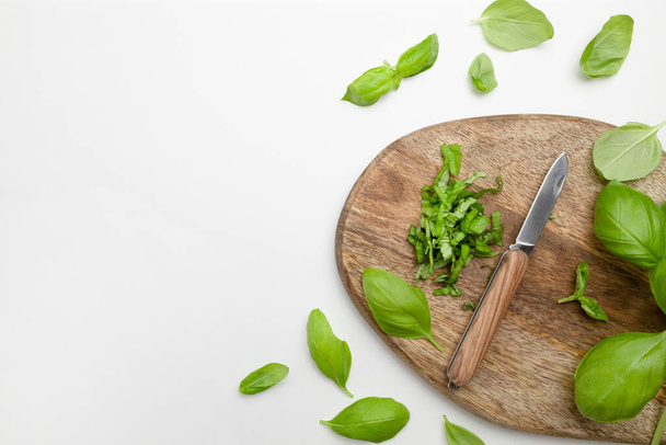Fresh organic basilic leaves on a wooden board for cooking - Zdjęcie, obraz