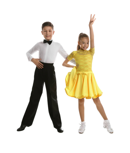 Beautifully dressed couple of kids dancing on white background - Foto, Imagen