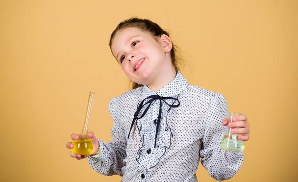 Education concept. Safety measures. Small kid study. Chemistry lesson. Insight and invention. Educative experiment. Chemistry fun. Schoolgirl with colorful chemical liquids. Having fun with chemistry - Фото, изображение