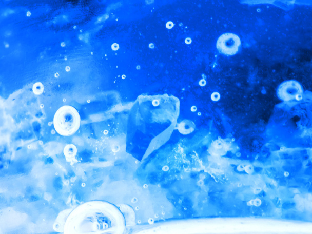 Abstract composition with sugar cubes in a jar with sweetness (inverted colors). It looks like water with bubbles and ice cubes - Φωτογραφία, εικόνα