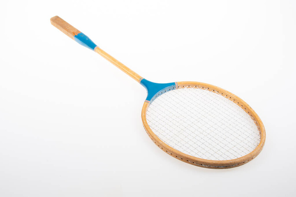 Vintage badminton racket in studio photo isolated on white background - 写真・画像