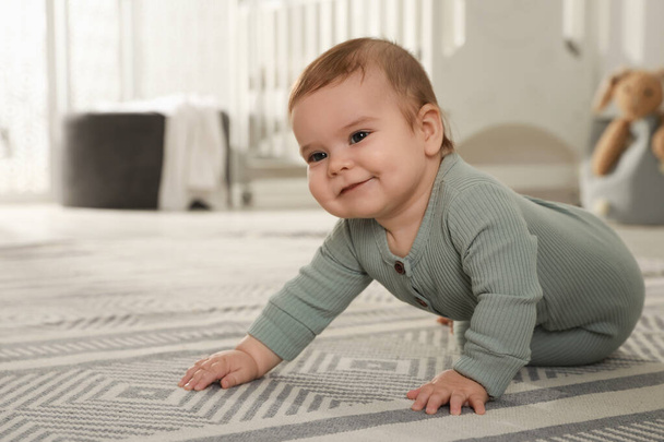 Cute baby crawling on floor at home - Valokuva, kuva