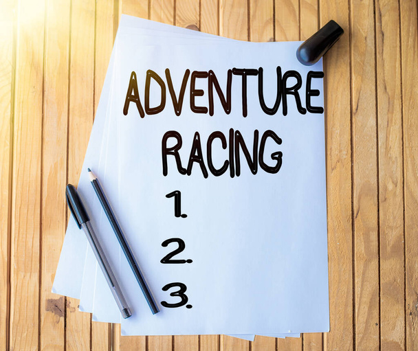 Handwriting text Adventure Racing. Conceptual photo disciplinary sport involving navigation over unknown course Office Stationery Paper Clipped Together Laying Flat On Table. - Photo, Image
