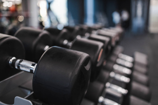 Rows of dumbbells on rack in gym - Foto, immagini