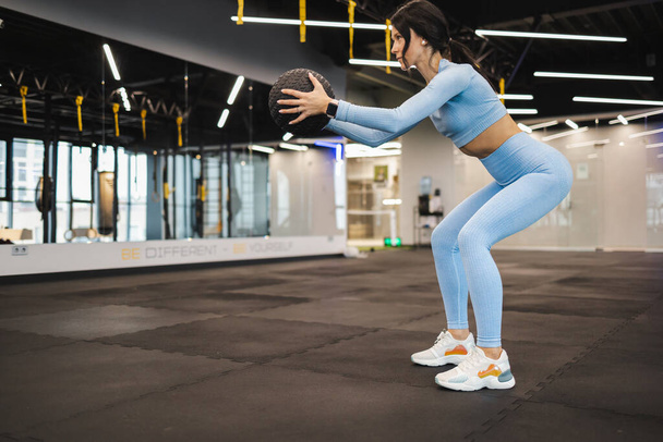 Woman doing squat with medicine ball - Photo, Image
