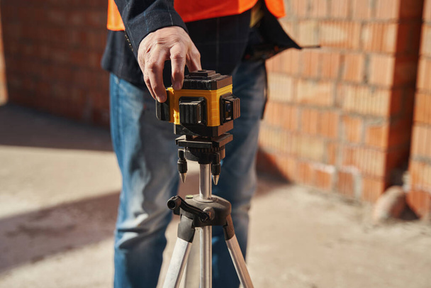 Laser level being used in professional construction process - Foto, imagen