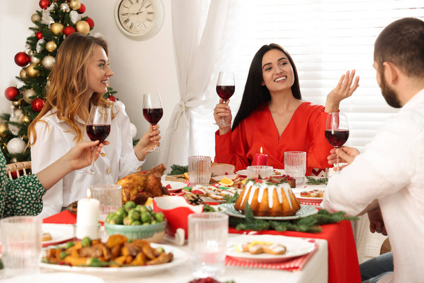 Happy family with their friends enjoying festive dinner at home. Christmas Eve celebration - Photo, image