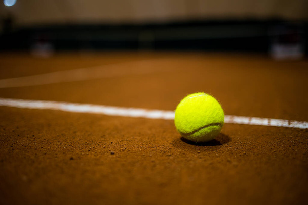 Tennis ball on the tennis court. Gravel. Tennis game. Sport, recreation concept - Fotografie, Obrázek