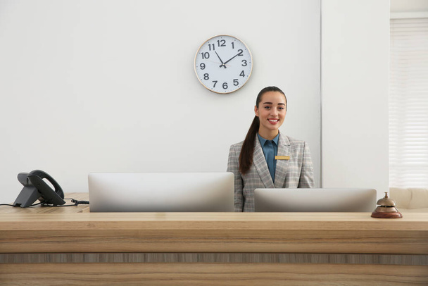 Portrait of beautiful receptionist at counter in hotel - Фото, зображення