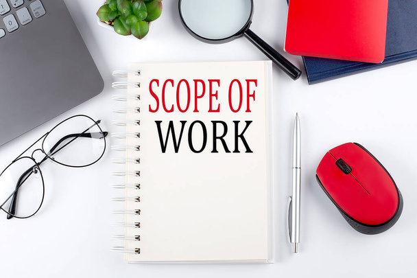 SCOPE OF WORK text on notepad with laptop on the white background - Photo, Image