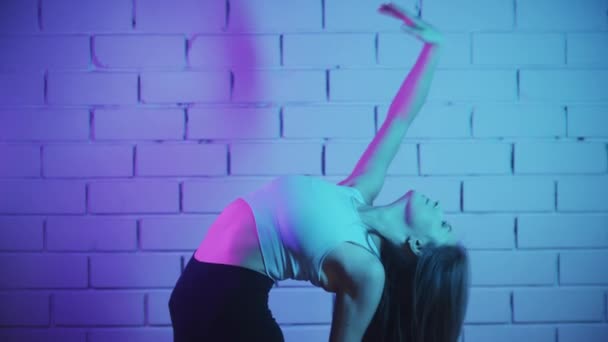 sporty skinny girl bends her back doing , Stock Video