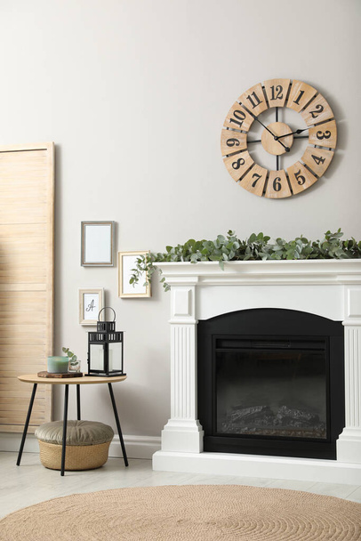 Stylish room decorated with beautiful eucalyptus garland on fireplace - Zdjęcie, obraz