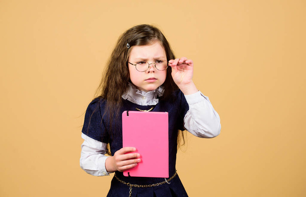 serious small girl wants to be teacher. notebook for diary notes. study lesson. knowledge and education. Back to school. hometwork. small girl with paper folder. School curriculum - Fotoğraf, Görsel