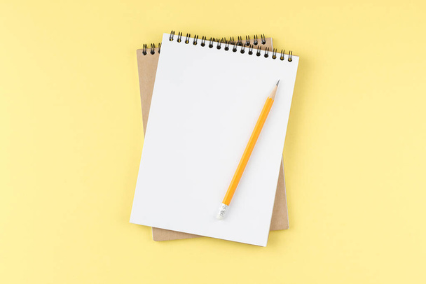 Spiral notepad on yellow background - Foto, imagen