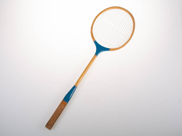 Old wooden blue badminton racket on grey background - Zdjęcie, obraz