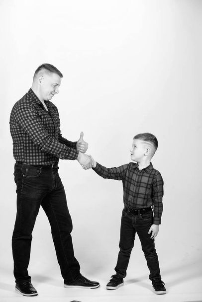 Parenthood concept. Fathers day. Father example of noble human. Cool guys. Father little son red shirts family look outfit. Best friends forever. Happiness being father of boy. Dad and adorable child - Фото, изображение