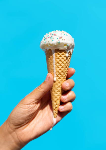 close up of hand holding waffle ice cream cone - Фото, изображение