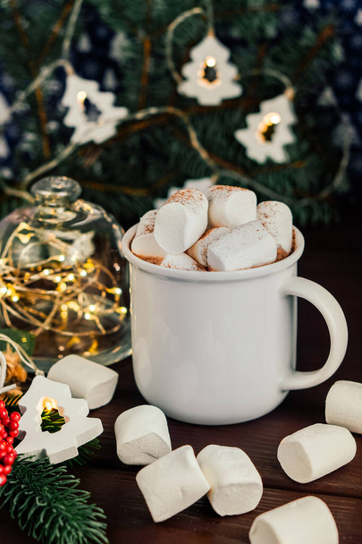 Christmas drink hot chocolate with marshmallows at festive illuminated decoration. Selective focus - Foto, immagini
