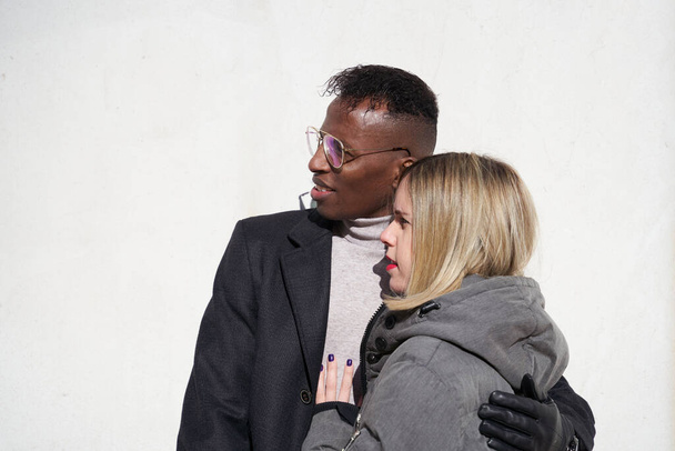 Young interracial couple hugging. Millennial lovers, african and white couple - 写真・画像