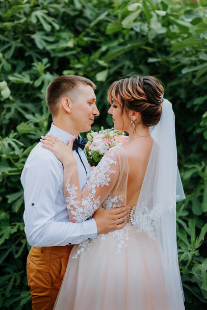 Sensual portrait of a young couple. Wedding photo outdoor. Wedding shot of bride and groom in park. Just married couple embraced. - Valokuva, kuva