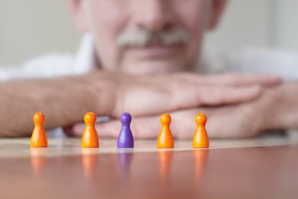 close-up of game pieces on table and businessman in his 50s - Zdjęcie, obraz