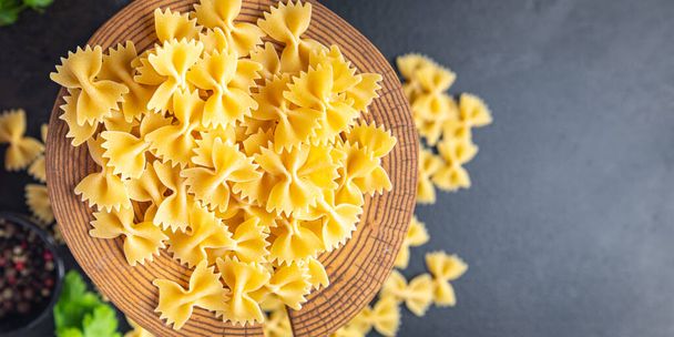 farfalle pasta raw bows durum wheat healthy meal food diet snack on the table copy space food background rustic. top view - Photo, Image
