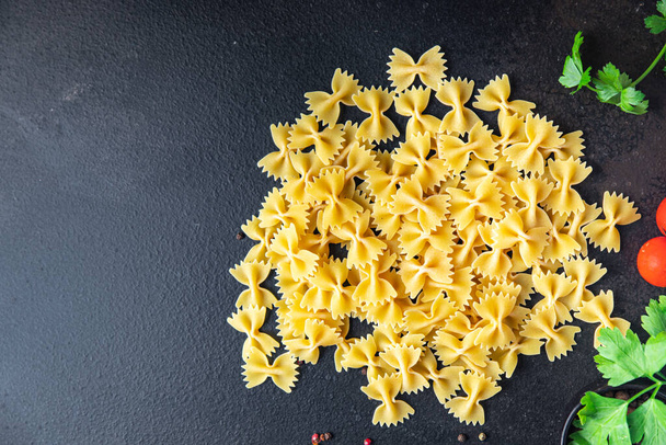 farfalle pasta raw bows durum wheat healthy meal food diet snack on the table copy space food background rustic. top view - Photo, Image
