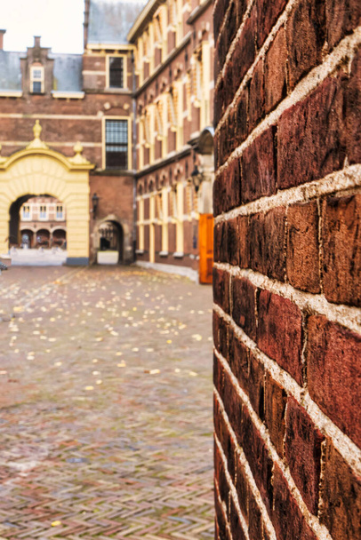 The Hague, Netherlands - October 22 2020 : brick historic wall and the courtyard of the "binnenhof" the medieval location where dutch parliament is located - Photo, image