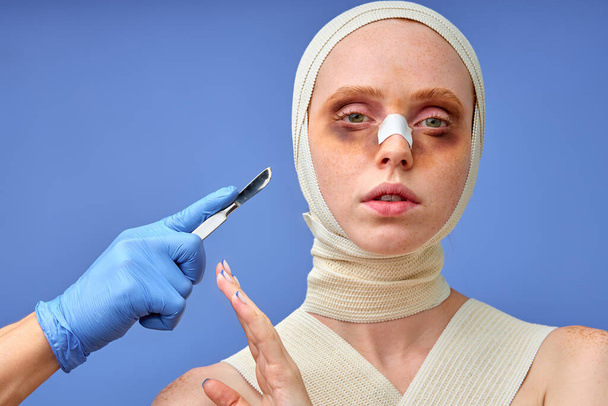 female in bandage looking at camera, say no to nurse, refuse from surgery, confident - 写真・画像