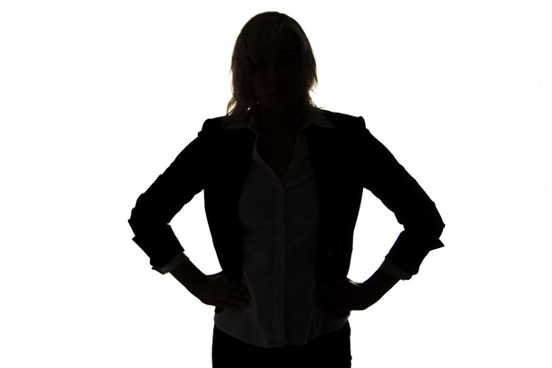 Silhouette of businesswoman with hands on hips - Photo, Image