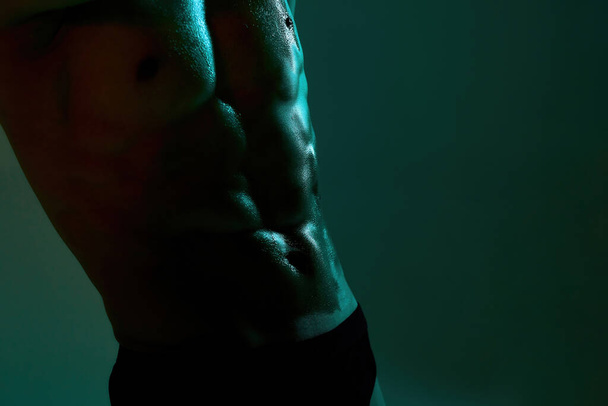 Close up of naked torso of athletic handsome man - Photo, image
