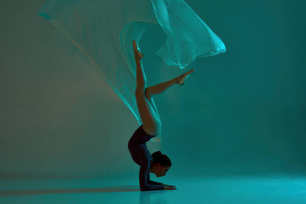 Side view of ballerina dancing ballet with cloth - Fotoğraf, Görsel