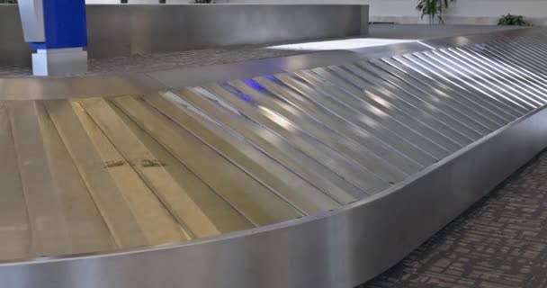 Χώρος αποσκευών με ιμάντα μεταφοράς στο σαλόνι αφίξεων του τερματικού σταθμού του αεροδρομίου - Πλάνα, βίντεο