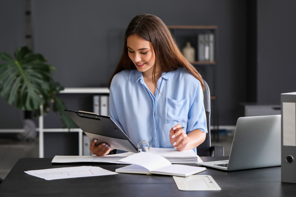 Young woman working with documents in office - Photo, Image