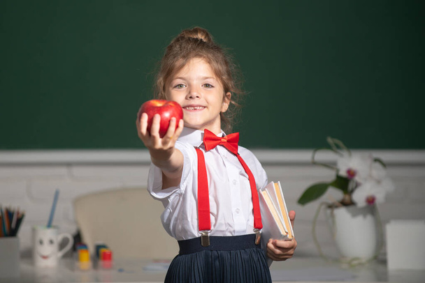 Portrait of cute, lovely, girl in school uniform in classroom. Educational process. - Photo, Image