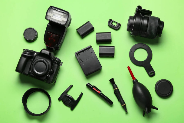 Flat lay of photo equipment on green background - Photo, Image