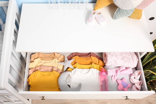 Drawer with baby clothes in children's bedroom - Photo, Image