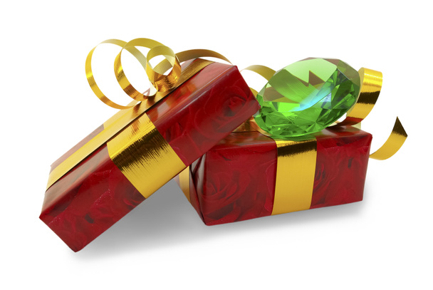 Red gift tied with gold ribbon with a green emerald on a white background - Photo, Image