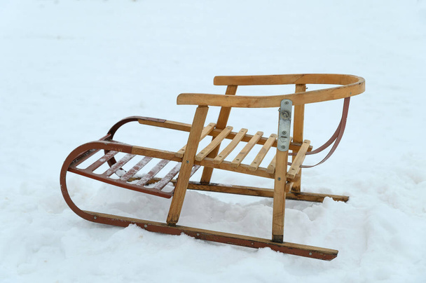 Antique wooden sleds with metal inserts and bindings. The sleds are on clean snow. - Photo, image