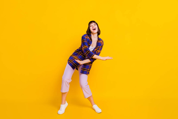 Full length body size view of attractive cheerful girl dancing having fun chill out isolated over bright yellow color background - Valokuva, kuva