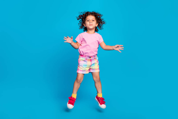 Full length body size view of attractive cheerful carefree funky girl jumping fooling isolated over vivid blue color background - Valokuva, kuva