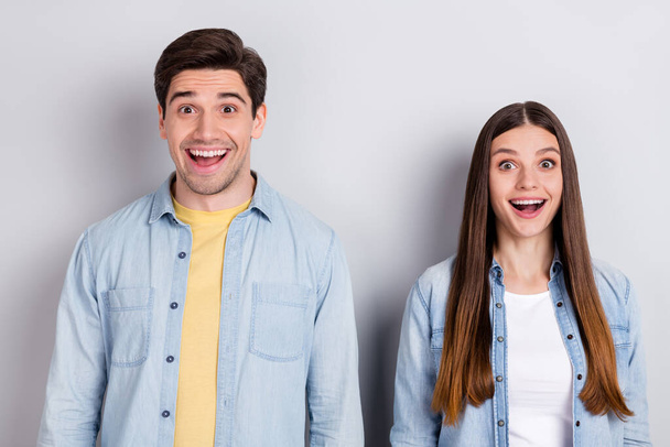 Photo of funny impressed brother sister dressed denim shirts smiling open mouth isolated grey color background - Φωτογραφία, εικόνα