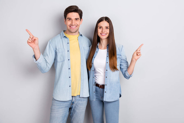 Photo of sweet charming sister brother wear jeans shirts hugging pointing empty space isolated grey color background - Φωτογραφία, εικόνα