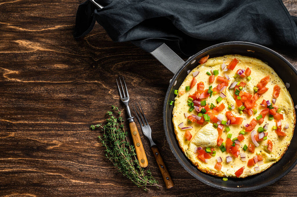 Healthy breakfast food, Stuffed egg omelet with vegetables in a skelet. Wooden background. Top view. Copy space - Foto, Imagen