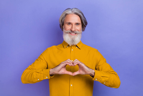 Photo of cheerful man show fingers heart symbol cupid romantic isolated over purple color background - Fotoğraf, Görsel