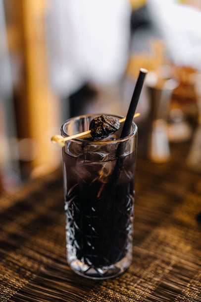 Dark drink in a glass glass at a buffet table - Fotoğraf, Görsel