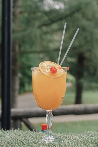 Glass with orange juice orange and straw - 写真・画像